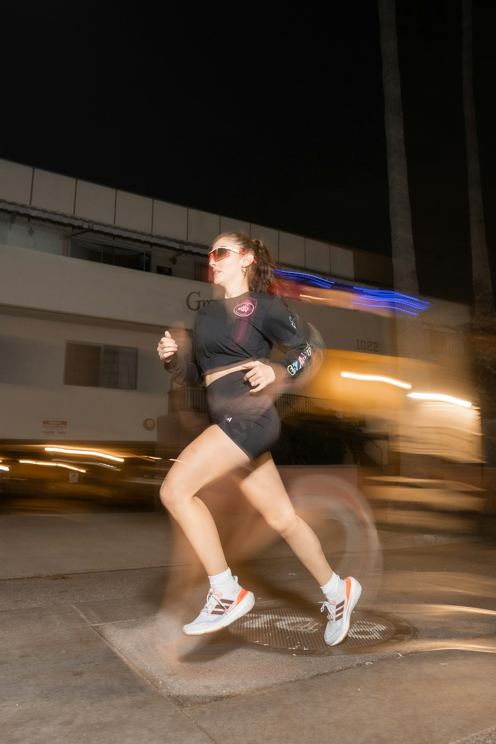 Mulher correndo à noite pela cidade